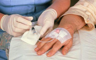 Chemotherapy: drug injected into catheter in hand