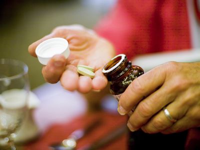 Hands of a woman holding supplements