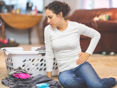 A woman on the floor with pelvic pain