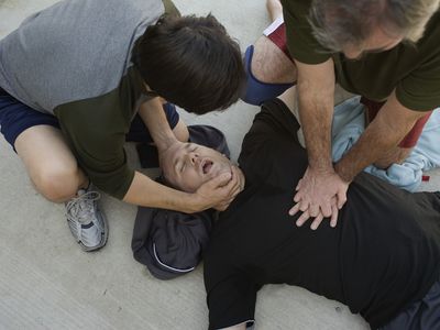 men doing cpr on another man