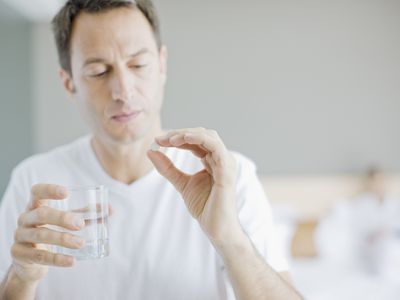 Man holding pill medication