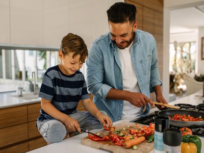 Father and son preparing vegetables 