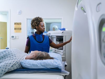 technician preparing scanner for patient