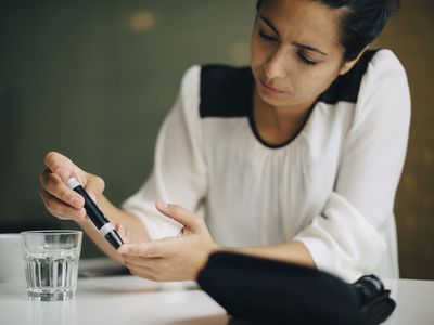 Woman checking blood sugar