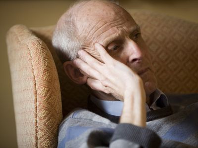 Elderly man with head resting on his hand