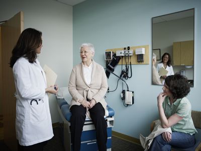 Mature female patient in exam room with doctor