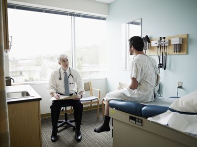 Male patient and doctor in discussion in exam room