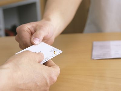 A patient presents a health insurance card.