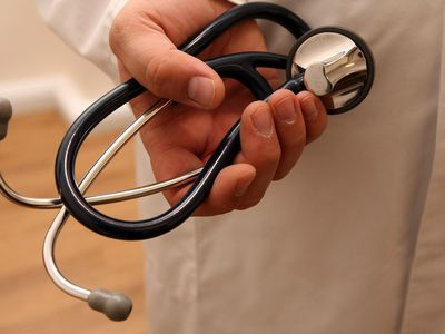 Hand grasping stethoscope