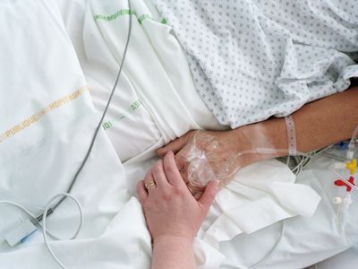 Hospital patient holding hand