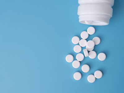 Glucophage (metformin) pills spilling out of a container