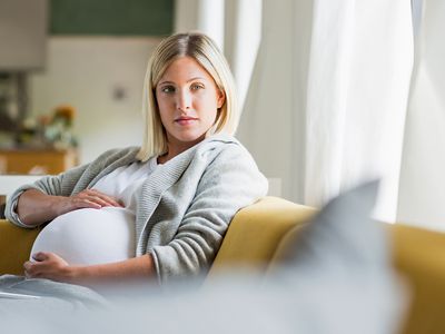 a pregnant woman holding her belly