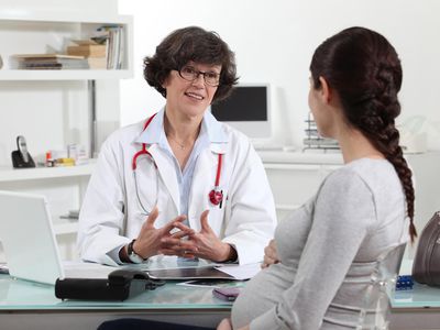 pregnant woman talking to doctor