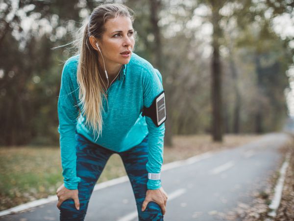 A runner catches their breath during a run outdoors