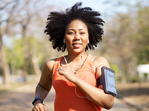 A person running outdoors wearing an armband