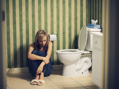 Sad young woman in bathroom