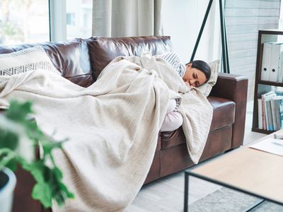 Woman lying on couch sick