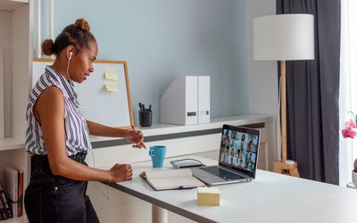 Person working at a standing desk with laptop