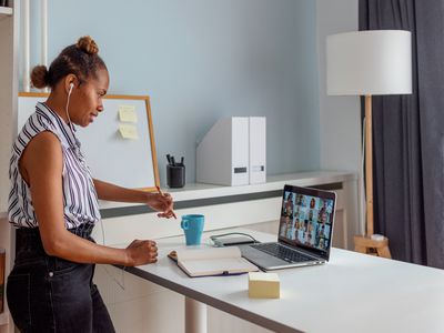 Person working at a standing desk with laptop