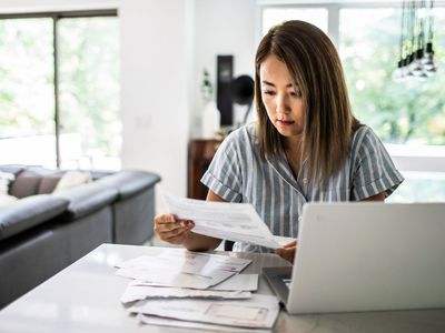 Woman paying bills at home - stock photo