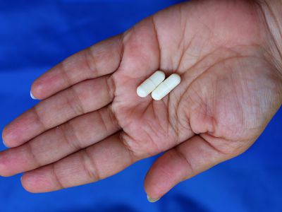 Chitosan capsules lying in a person's hand