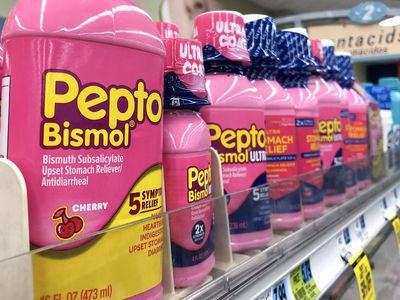 Bottles of Pepto Bismol sitting on a pharmacy shelf