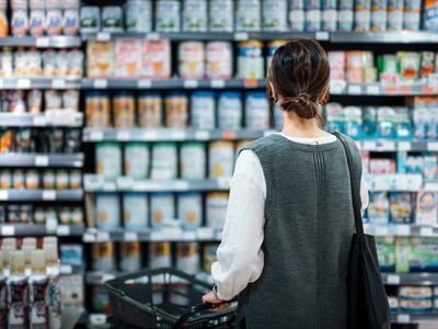 woman standing in front of pharmacy aisle 