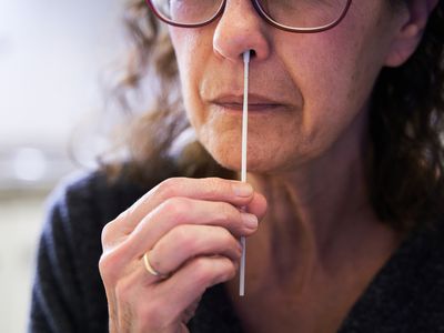 woman swabbing her nose