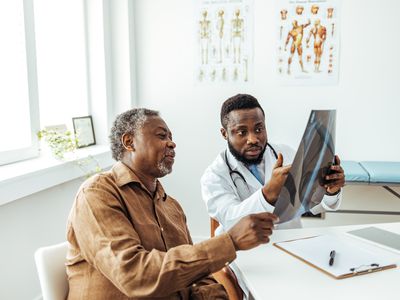 A healthcare provider and patient looking at an x-ray. 