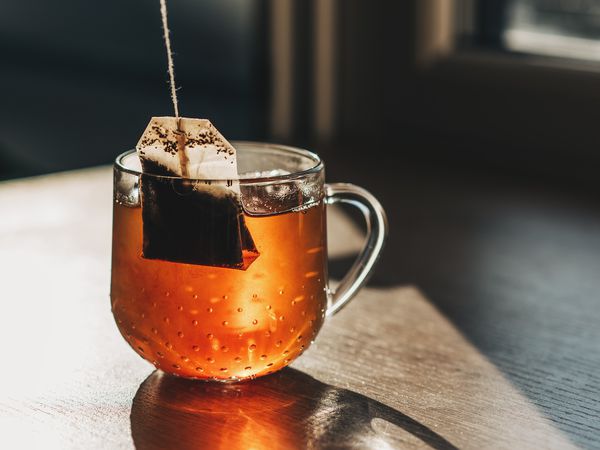 Tea bag put in transparent glass teacup