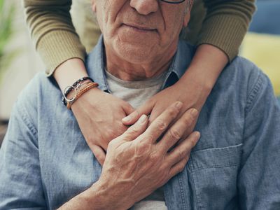 Comforting hand on shoulder of man