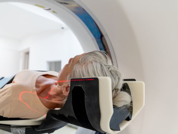 A mature person in a CAT scan machine. 