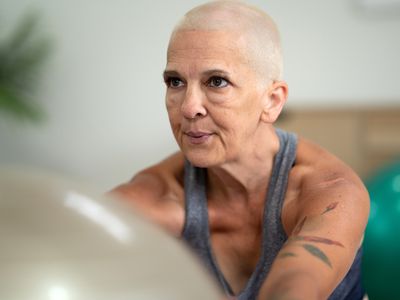 Older adult woman exercising with yoga ball