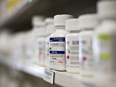 Close-up of bottle of Cymbalta on pharmacy shelf with blurred background