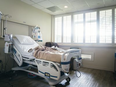 Hospital bed near sunny window