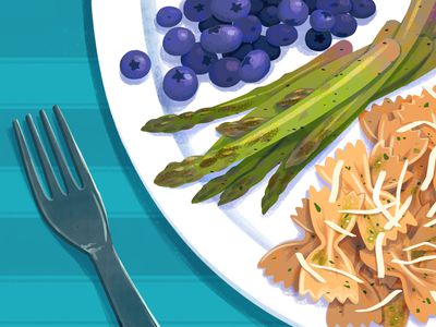 A plate with blueberries, asparagus, and pasta with a fork for the DASH diet