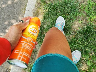 Person using OFF! Active Insect Repellent I (15% DEET) on their leg