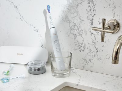 Philips Sonicare DiamondClean Electric Toothbrush in cup on a marble bathroom sink