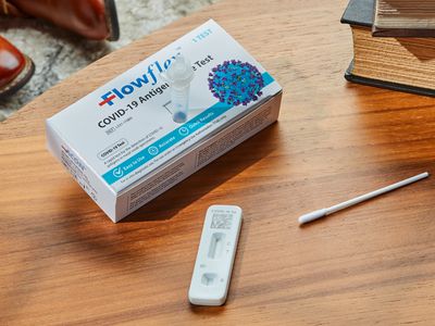 Flowflex COVID-19 Antigen Rapid Home Test Kit displayed on wooden table