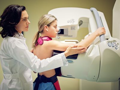 Imaging technologist is working with mammography X-ray scanner in hospital - stock photo