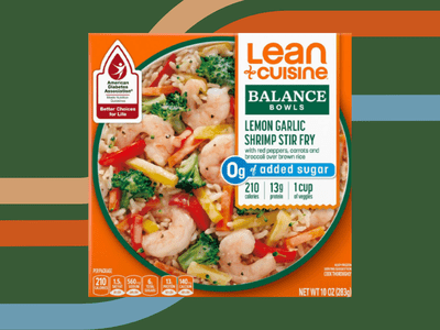 A Lean Cuisine Balance Bowl frozen meal on a green lined background.